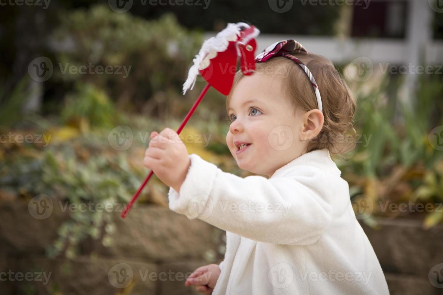 Adorable Baby Girl Playing in Park photo