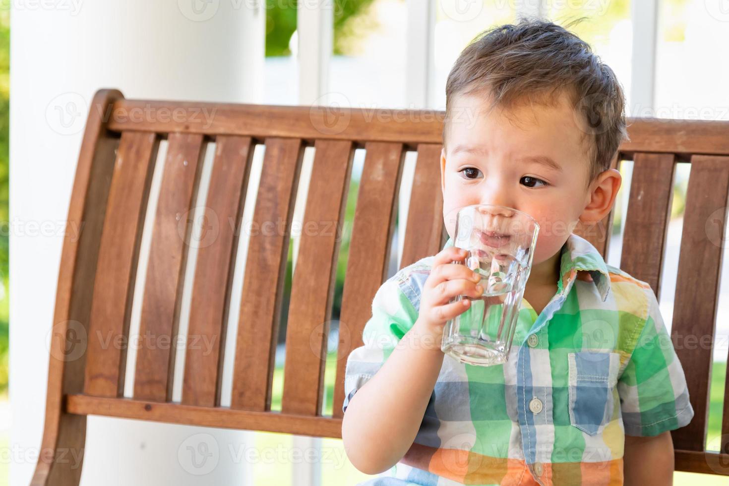 Mixed Race Chinese and Caucasian Boy Enjoying A Glass Of Water photo