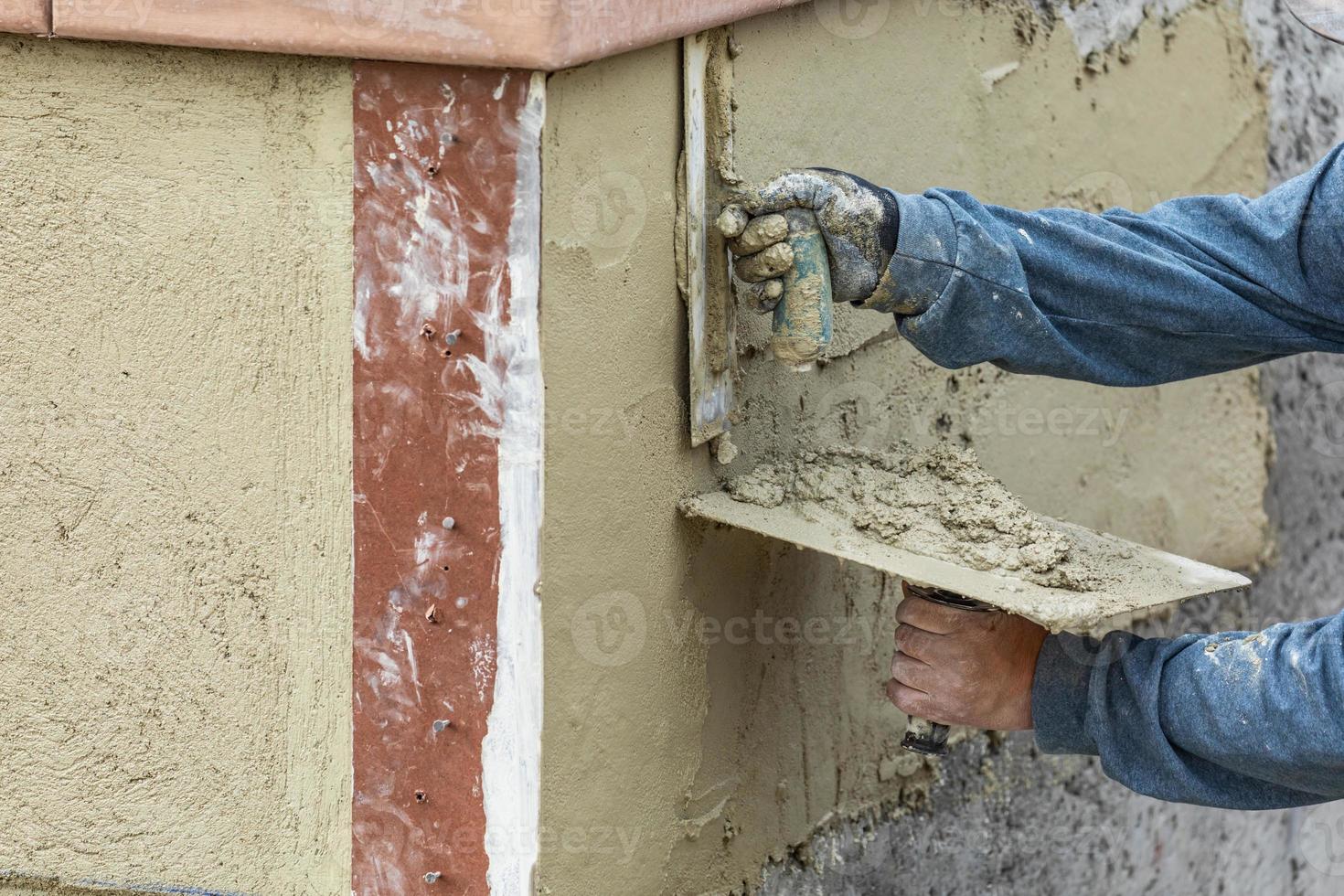 Tile Worker Applying Cement with Trowel at Pool Construction Site photo