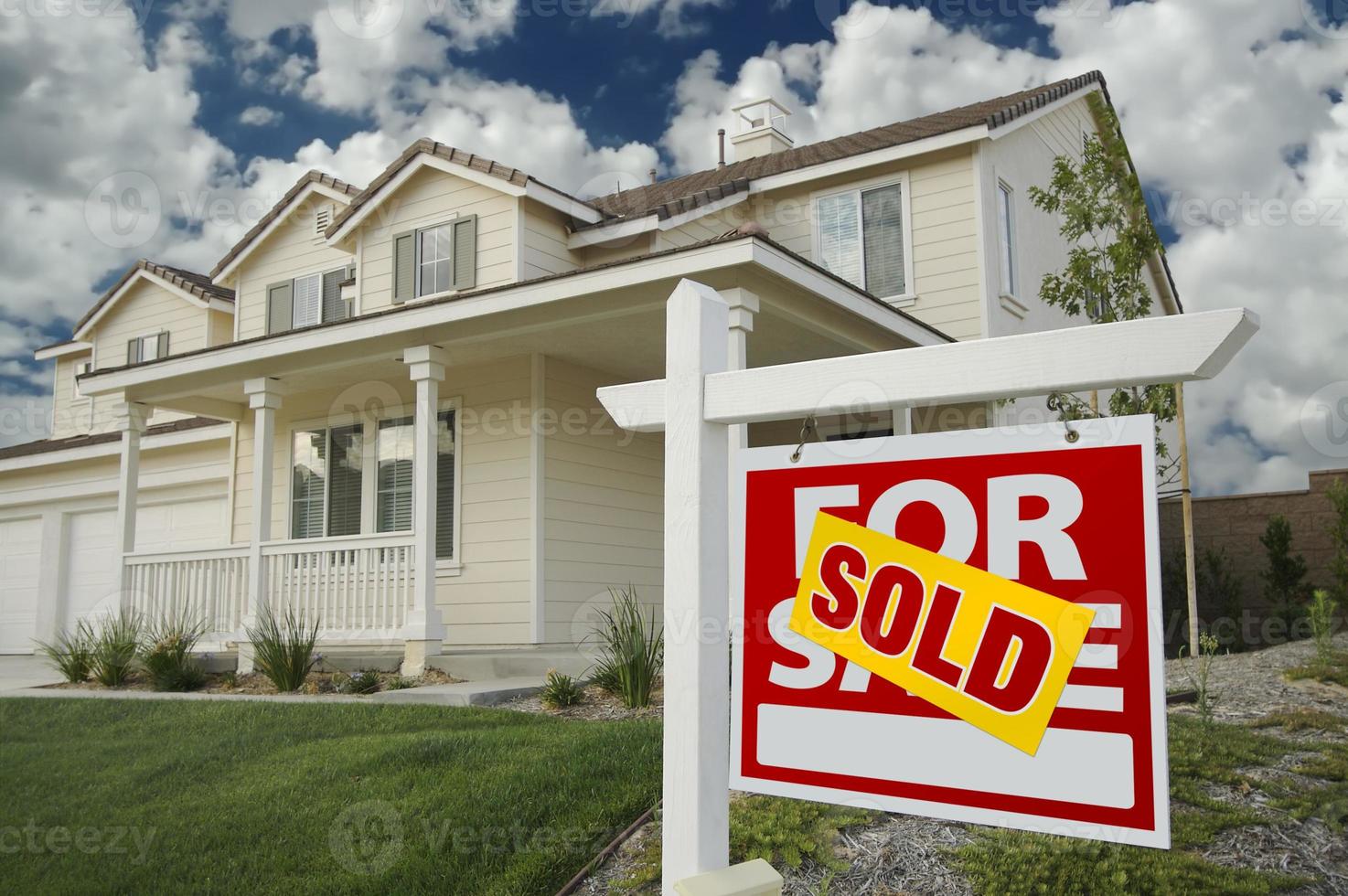 Sold Home For Sale Sign and House photo