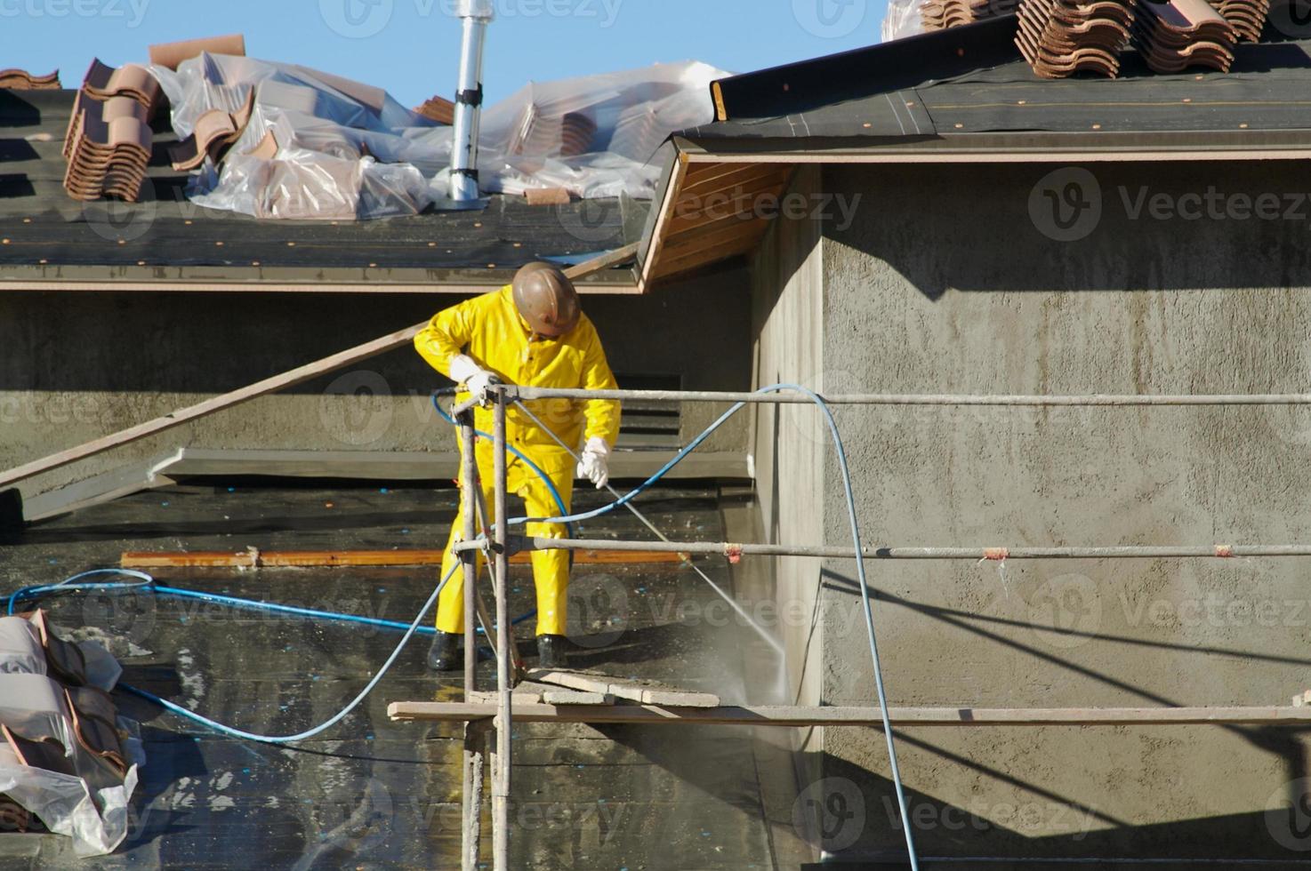 Construction Worker Pressure Washes photo