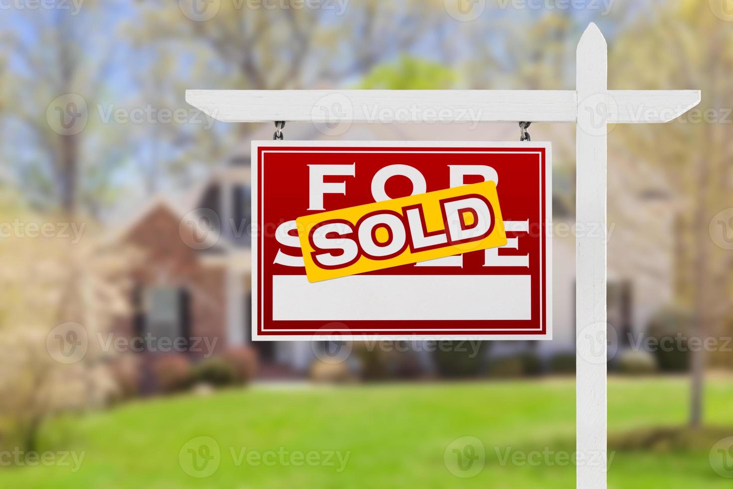 Left Facing Sold For Sale Real Estate Sign In Front of House. photo