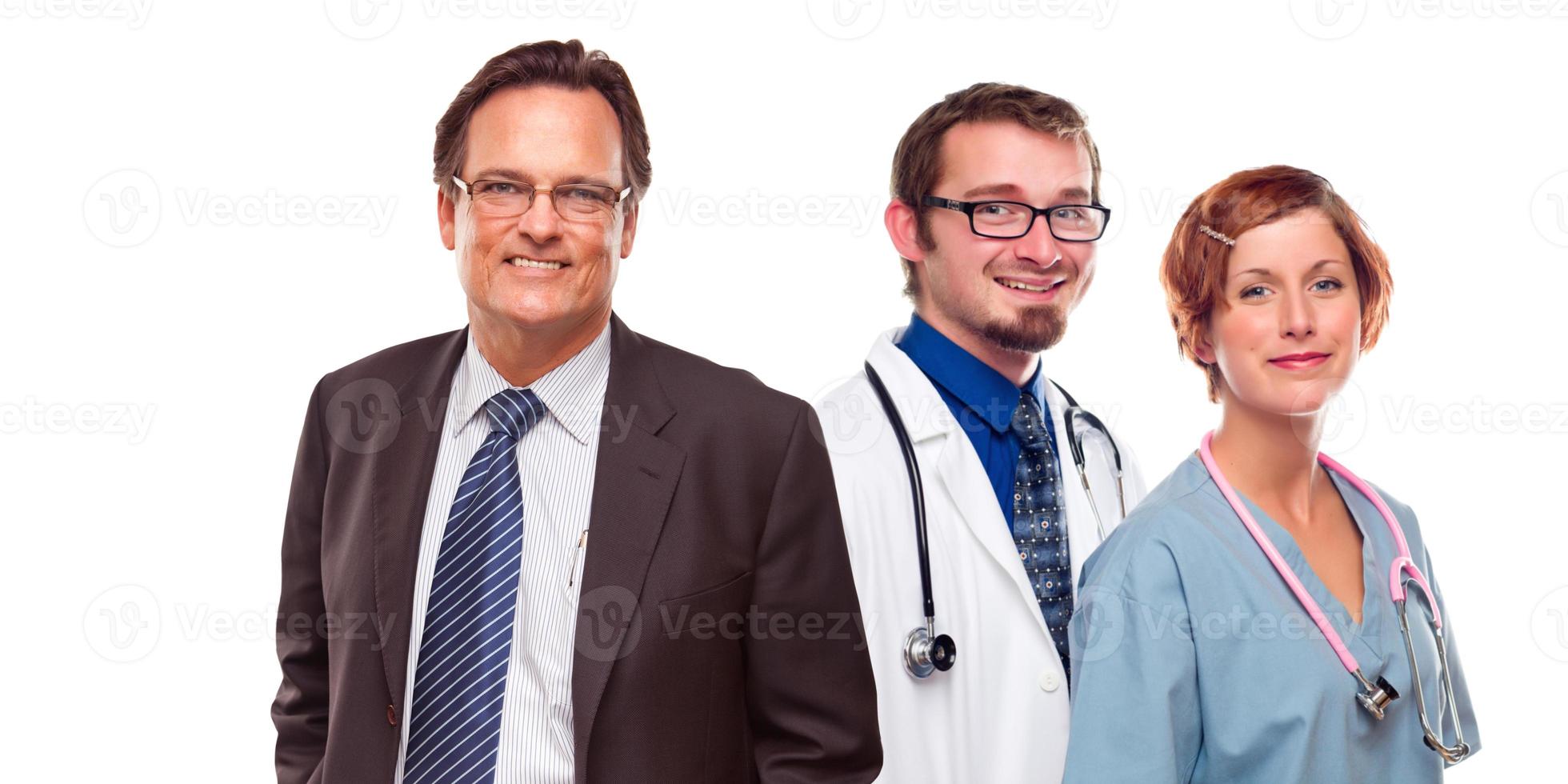 Friendly Male and Female Doctors with Businessman on White photo