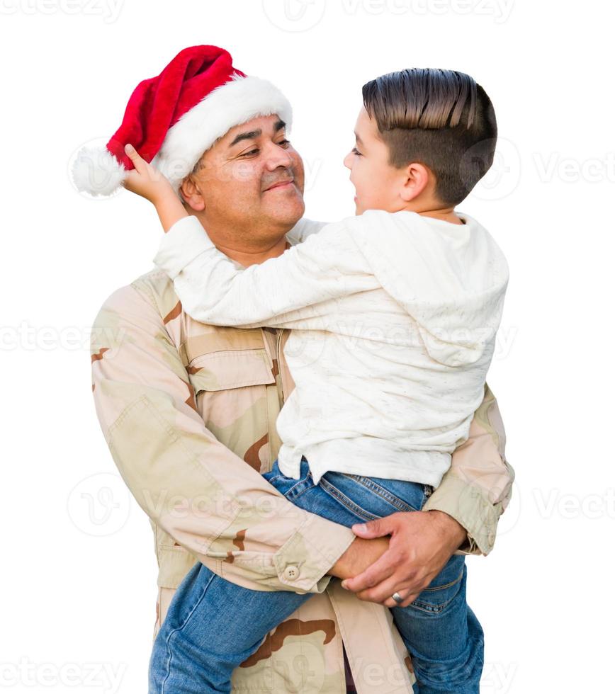 Hispanic Male Soldier Wearing Santa Cap Holding Mixed Race Son Isolated on a White Background photo