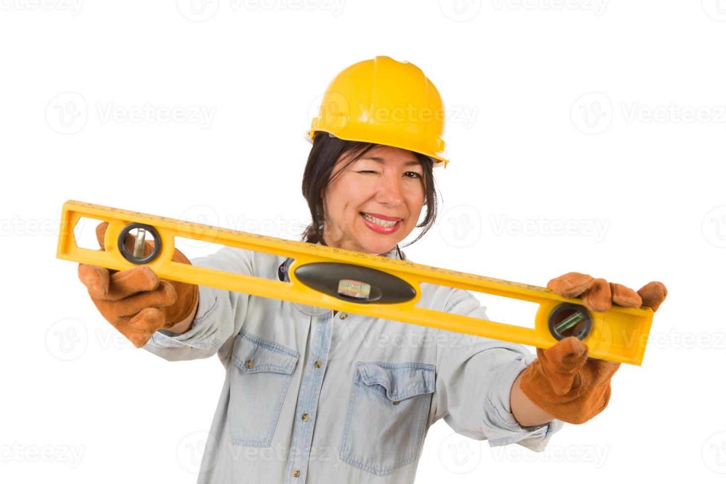 Hispanic Female Contractor Holding Level Wearing Hard Hat Isolated on White Background photo