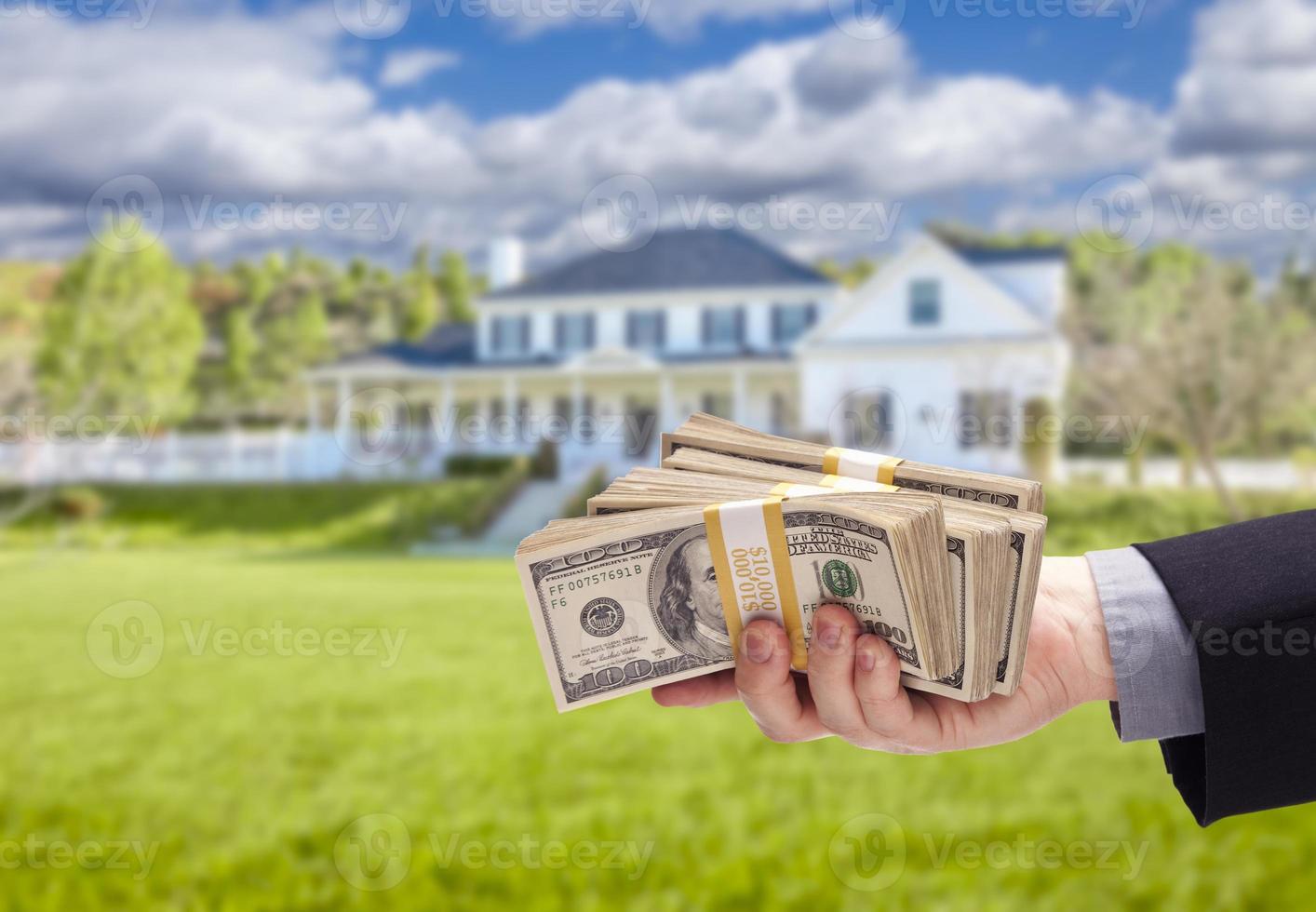 Handing Over Cash For House in Front of Home photo