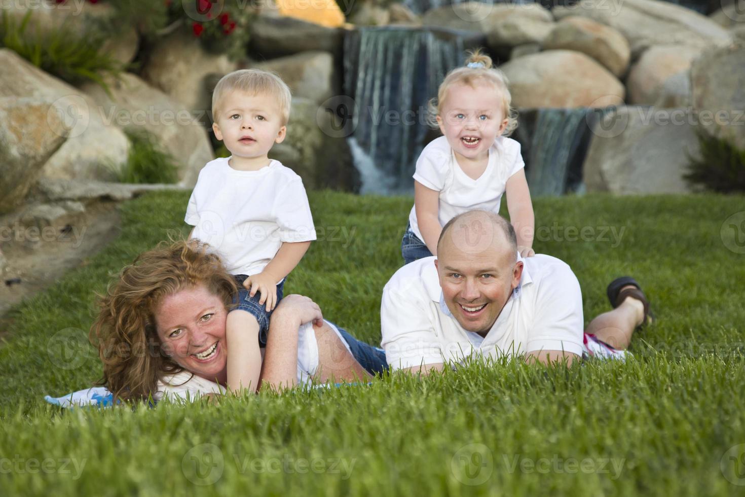 Happy Young Family with Twins Portrait in Park photo