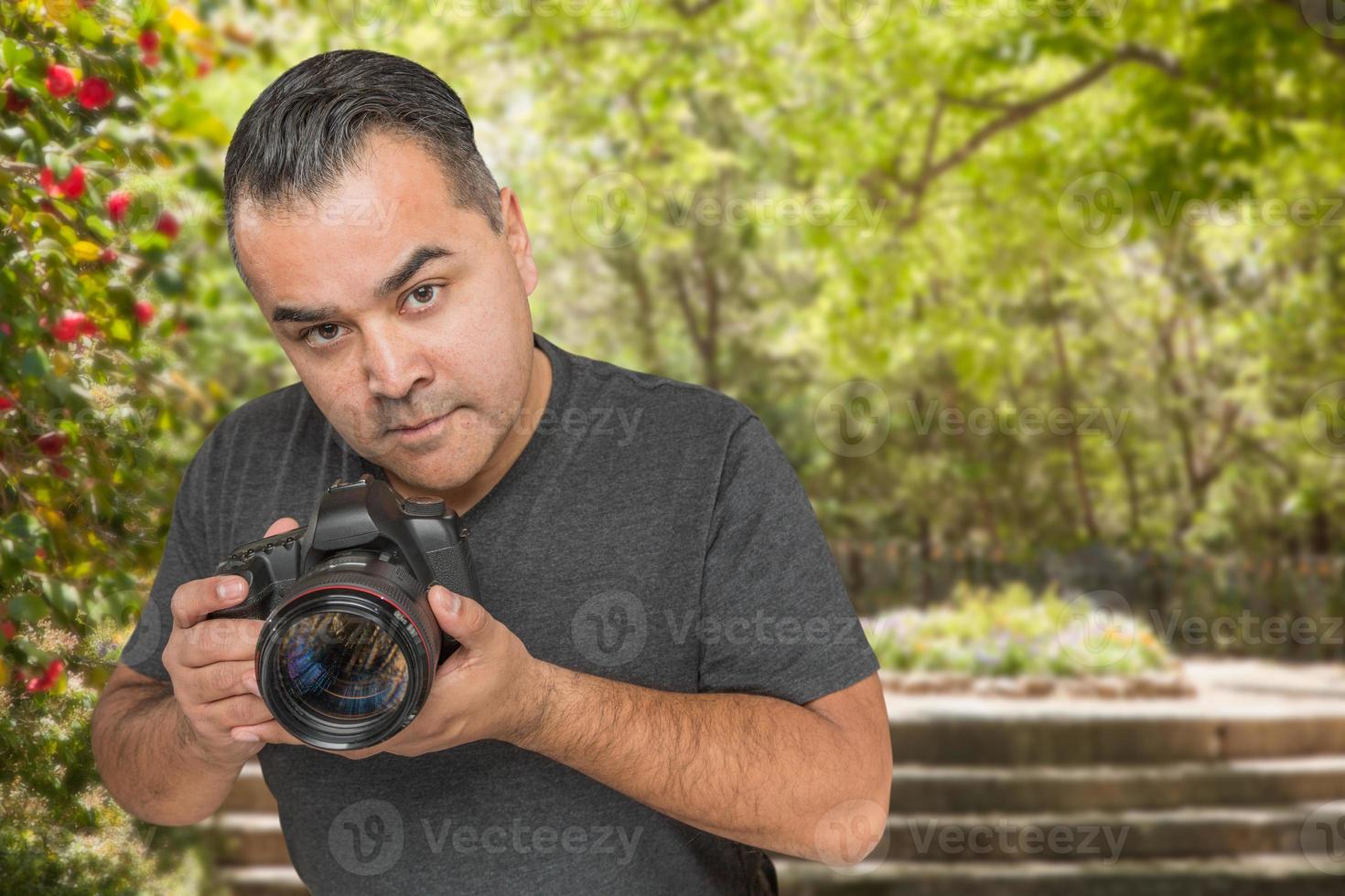 Hispanic Young Male Photographer With DSLR Camera Outdoors photo