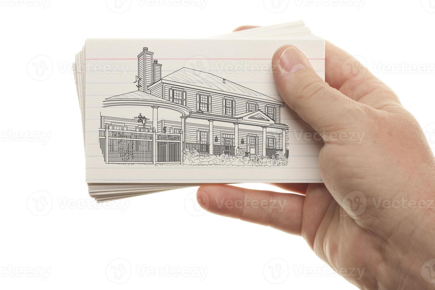 Male Hand Holding Stack of Flash Cards with House Drawing photo