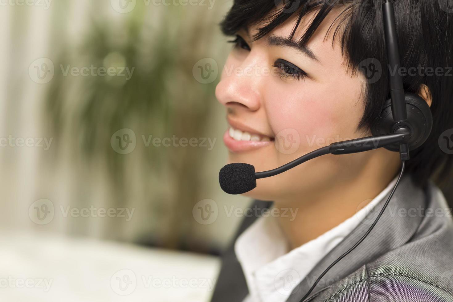 Attractive Young Mixed Race Woman Smiles Wearing Headset photo