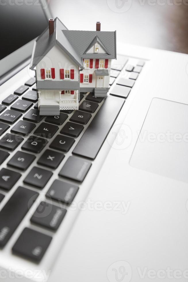 Miniature House on Laptop Computer photo