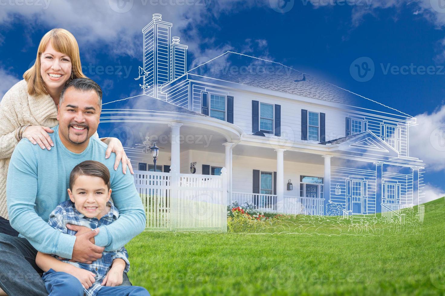 Young Mixed Race Family and Ghosted House Drawing on Grass photo