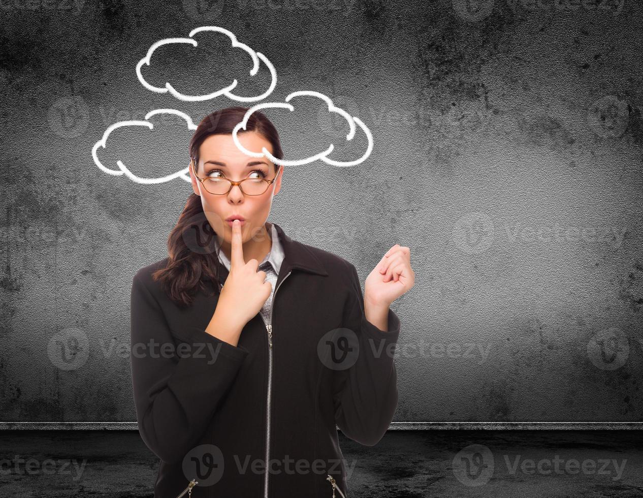 Clouds Drawn Around Head of Young Adult Woman In Front of Wall with Copy Space photo
