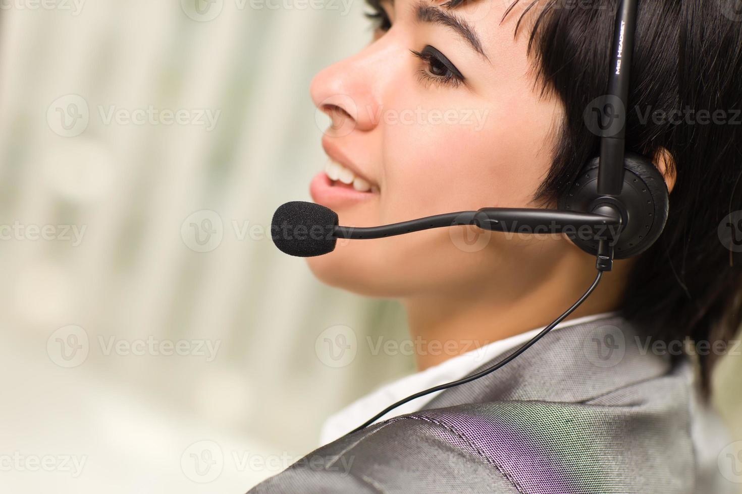 Profile of Attractive Young Mixed Race Woman Smiles Wearing Headset photo