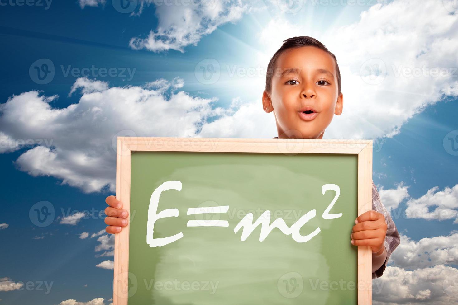 Proud Hispanic Boy Holding Chalkboard with Theory of Relativity photo