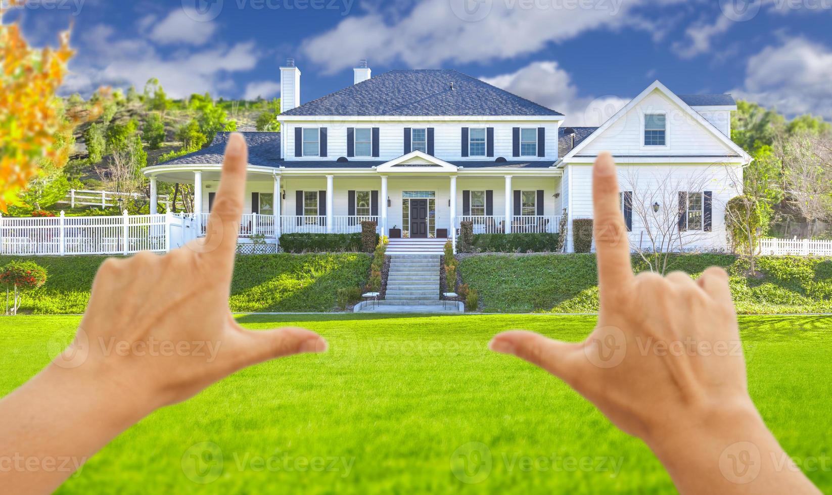 Female Hands Framing Beautiful House photo