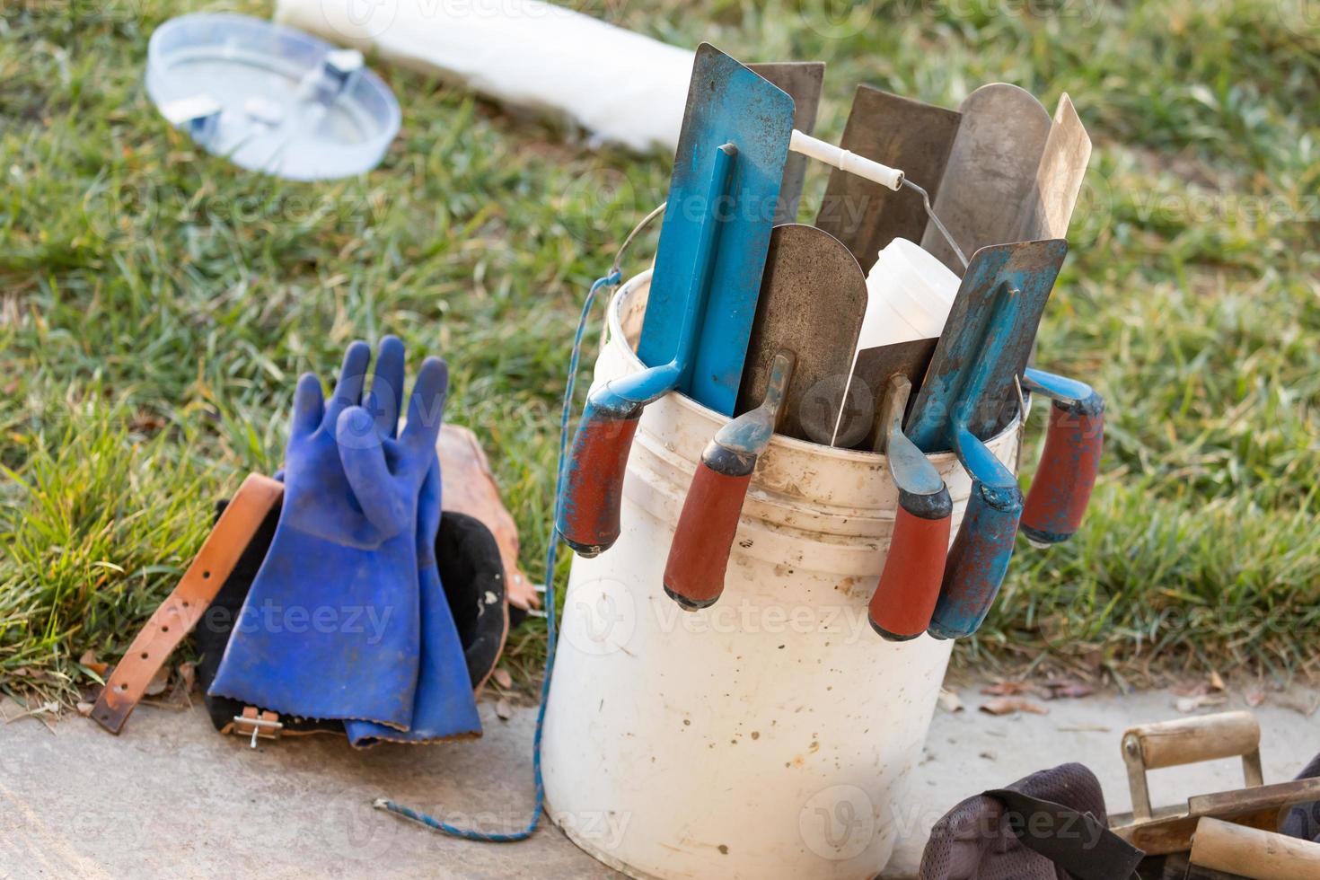 Bucket of Cement Trowels and Tools photo