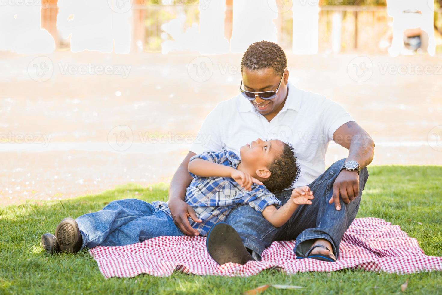 Happy African American Father and Mixed Race Son Playing At The Park photo