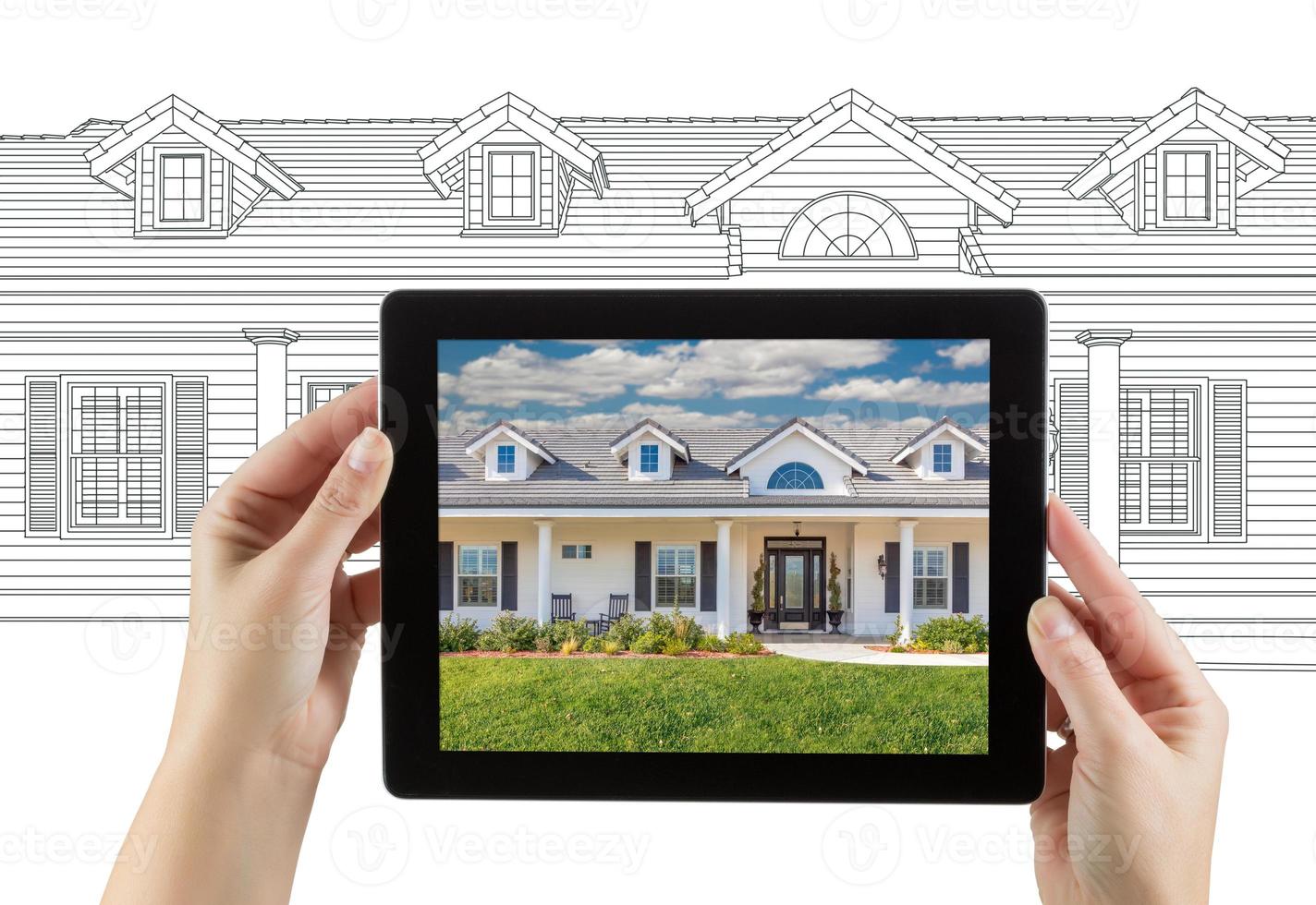 Female Hands Holding Computer Tablet with House Photo on Screen and Drawing Behind.