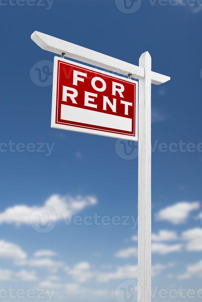 Left Facing For Rent Real Estate Sign on a Blue Sky with Clouds. photo