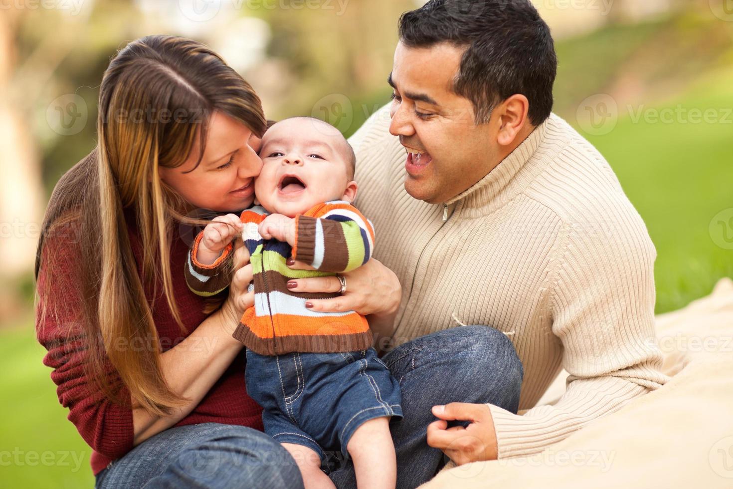 Happy Mixed Race Parents Playing with Their Son photo