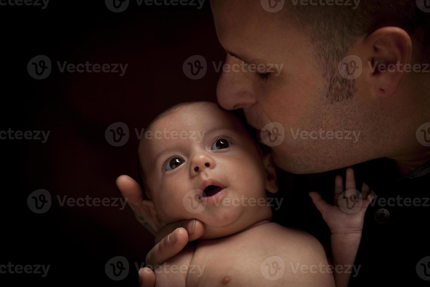 Young Father Holding His Mixed Race Newborn Baby photo