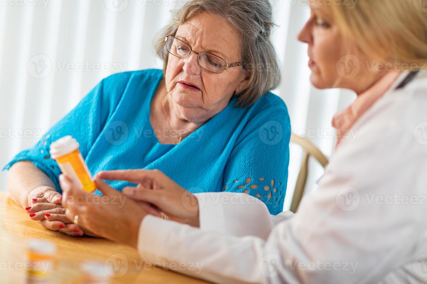 Female Doctor Talking with Senior Adult Woman About Medicine Prescription photo