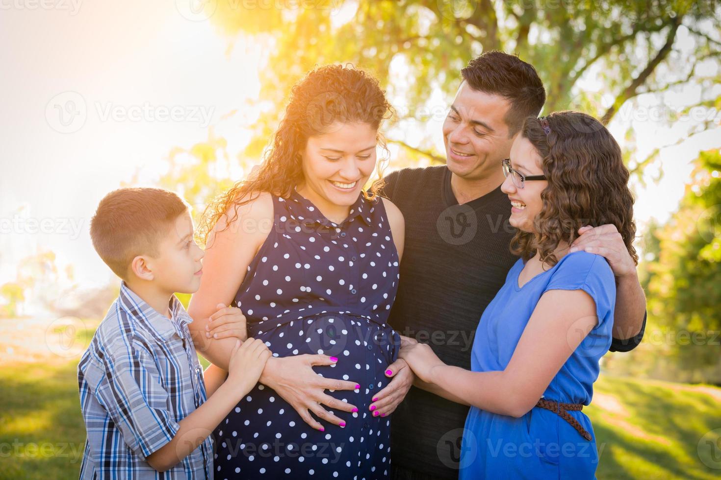 Hispanic Pregnant Family Portrait Outdoors photo