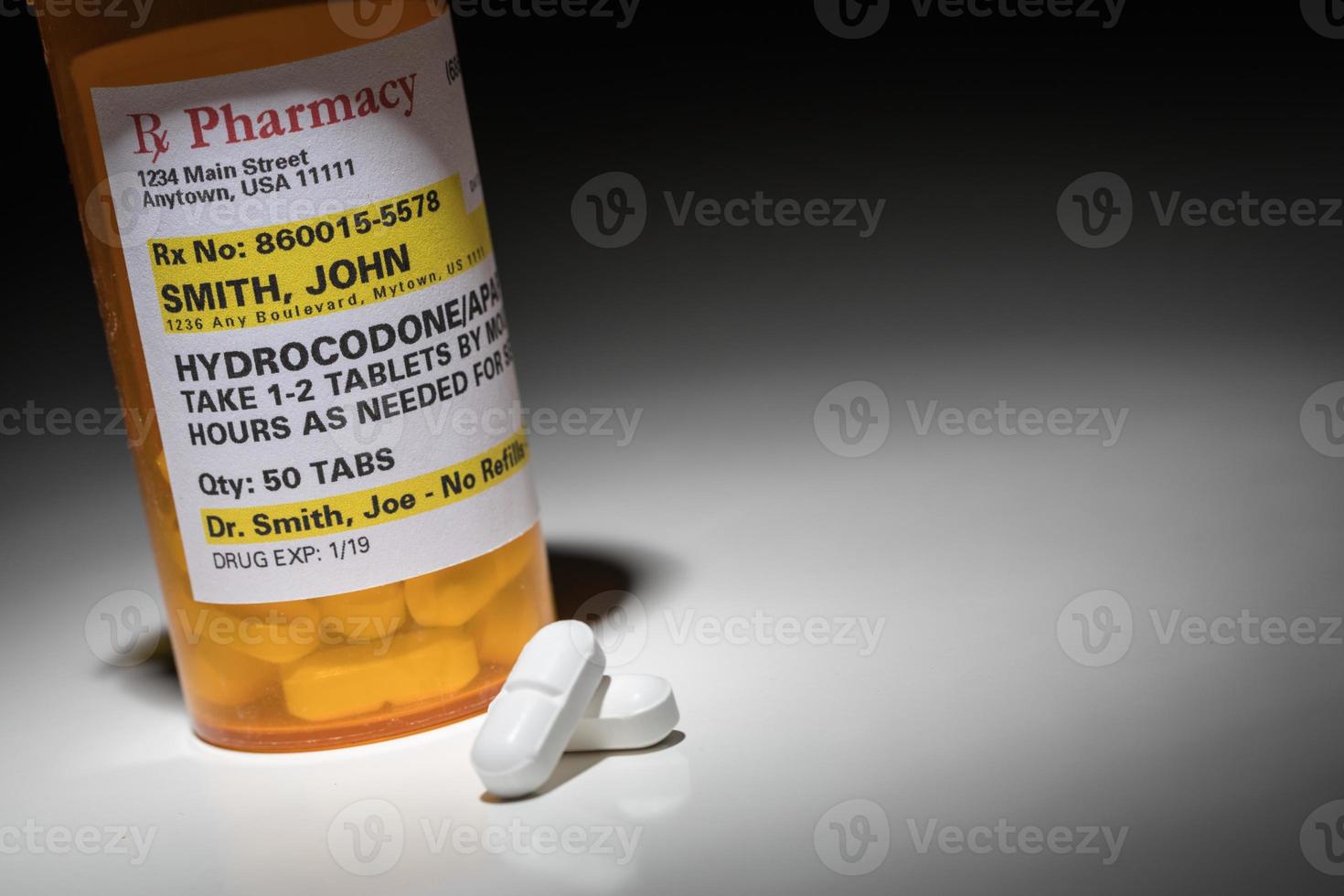 Hydrocodone Pills and Prescription Bottle with Non Proprietary Label. No model release required - contains fictitious information. photo