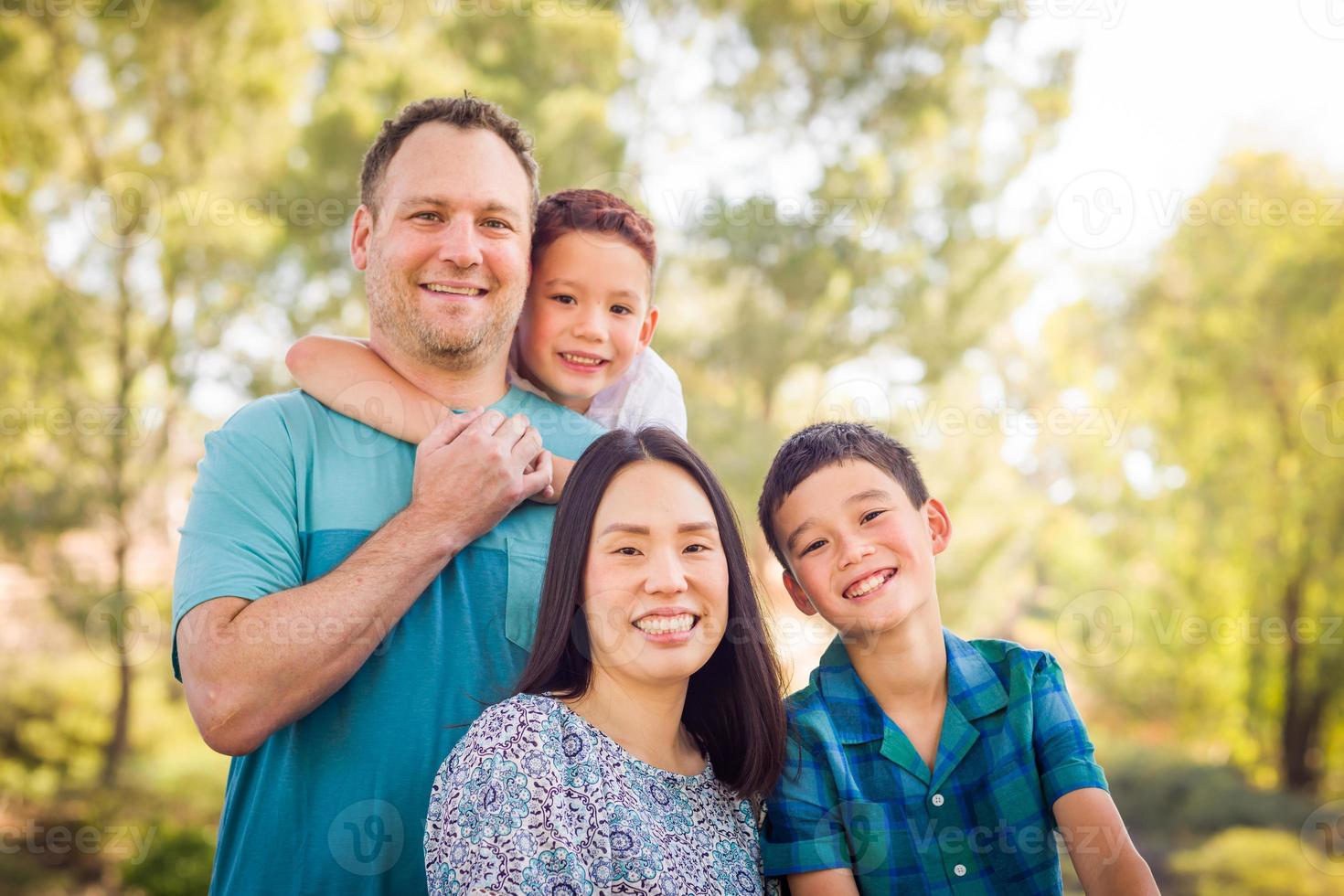 Outdoor portrait of biracial Chinese and Caucasian family. photo