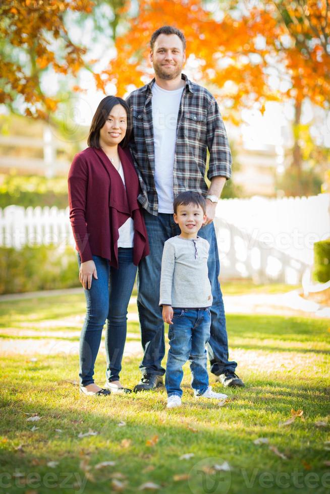 Outdoor portrait of Multiethnic Chinese and Caucasian family. photo