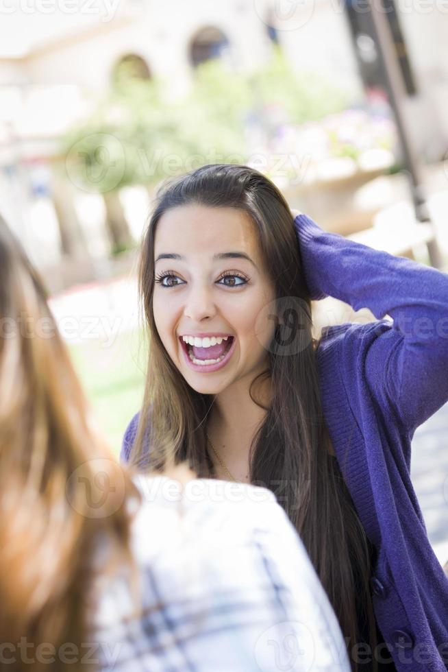 Expressive Young Mixed Race Female Sitting and Talking with Girlfriend photo