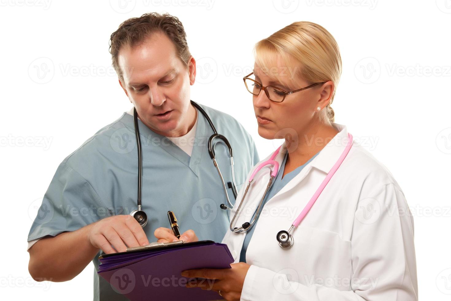 Male and Female Doctors Looking Over Files photo