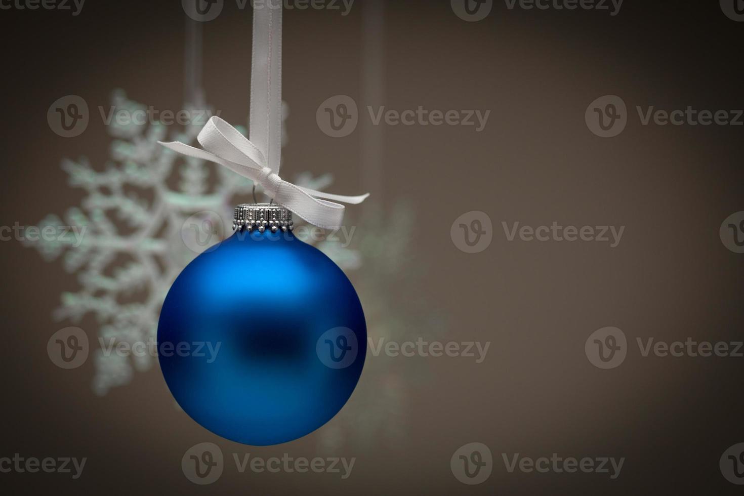 Snowflake and Blue Christmas Ornament Against Dark Background photo