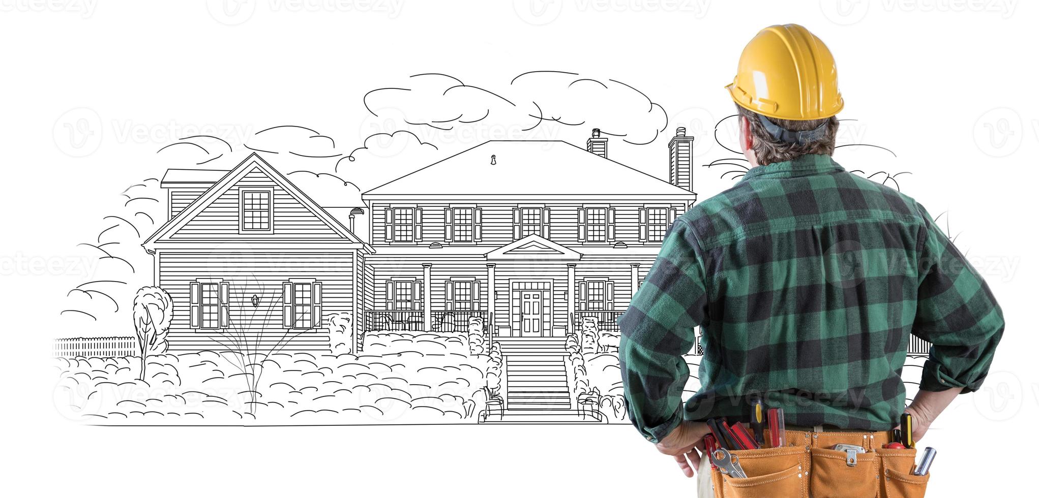Male Contractor with Hard Hat and Tool Belt Looking At Custom House Drawing On White. photo