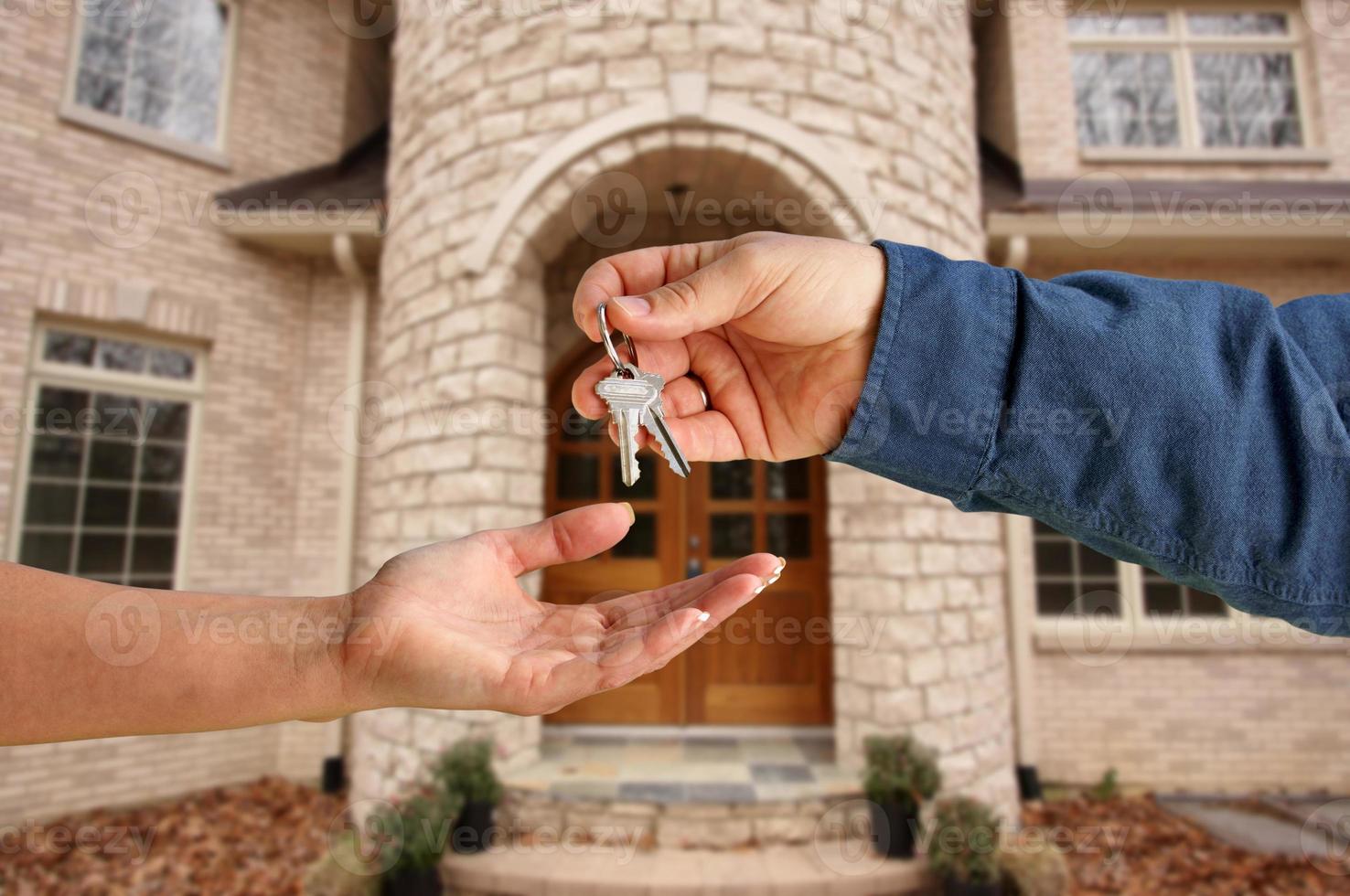 Handing Over the House Keys in Front of New Home photo