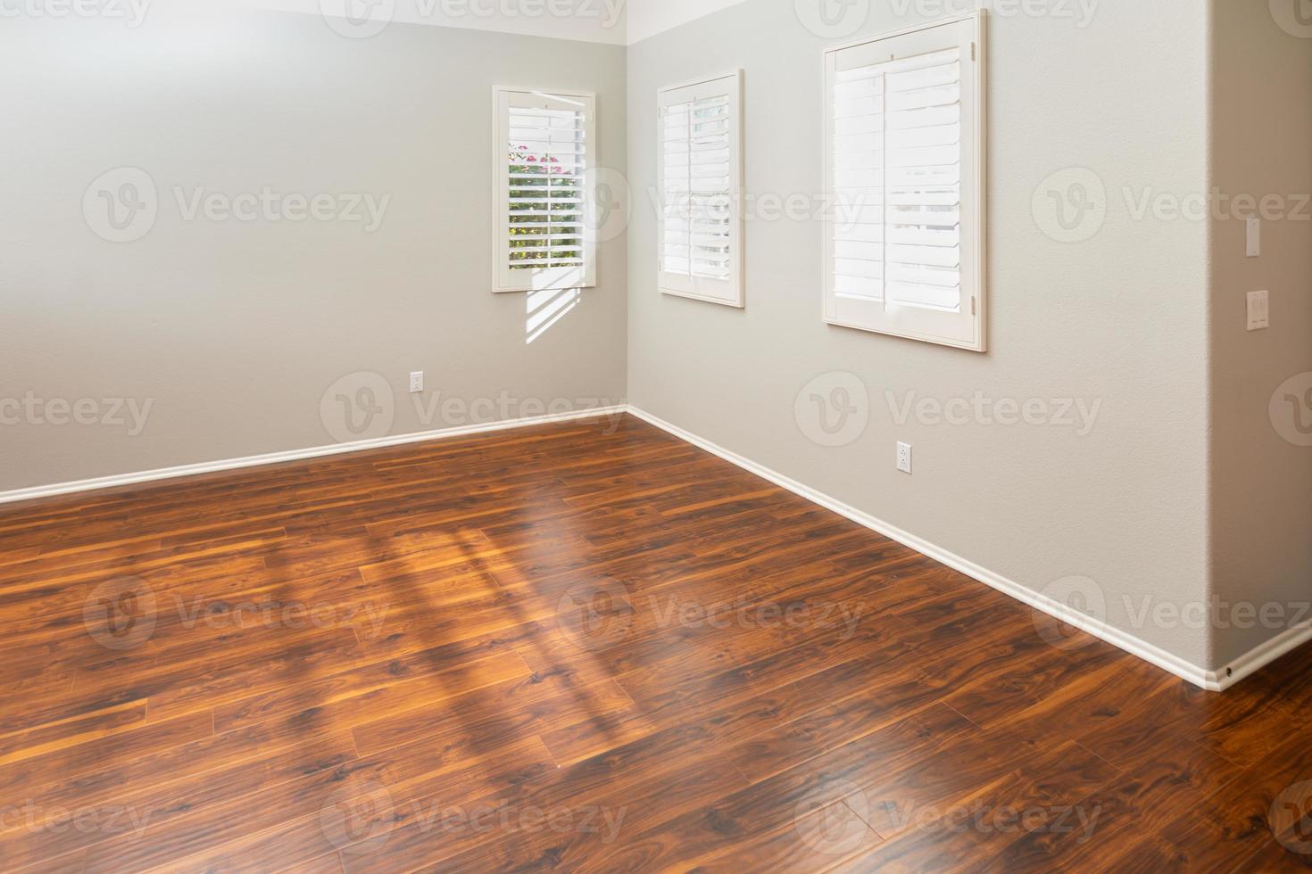 Newly Installed Brown Laminate Flooring and Baseboards in Home photo