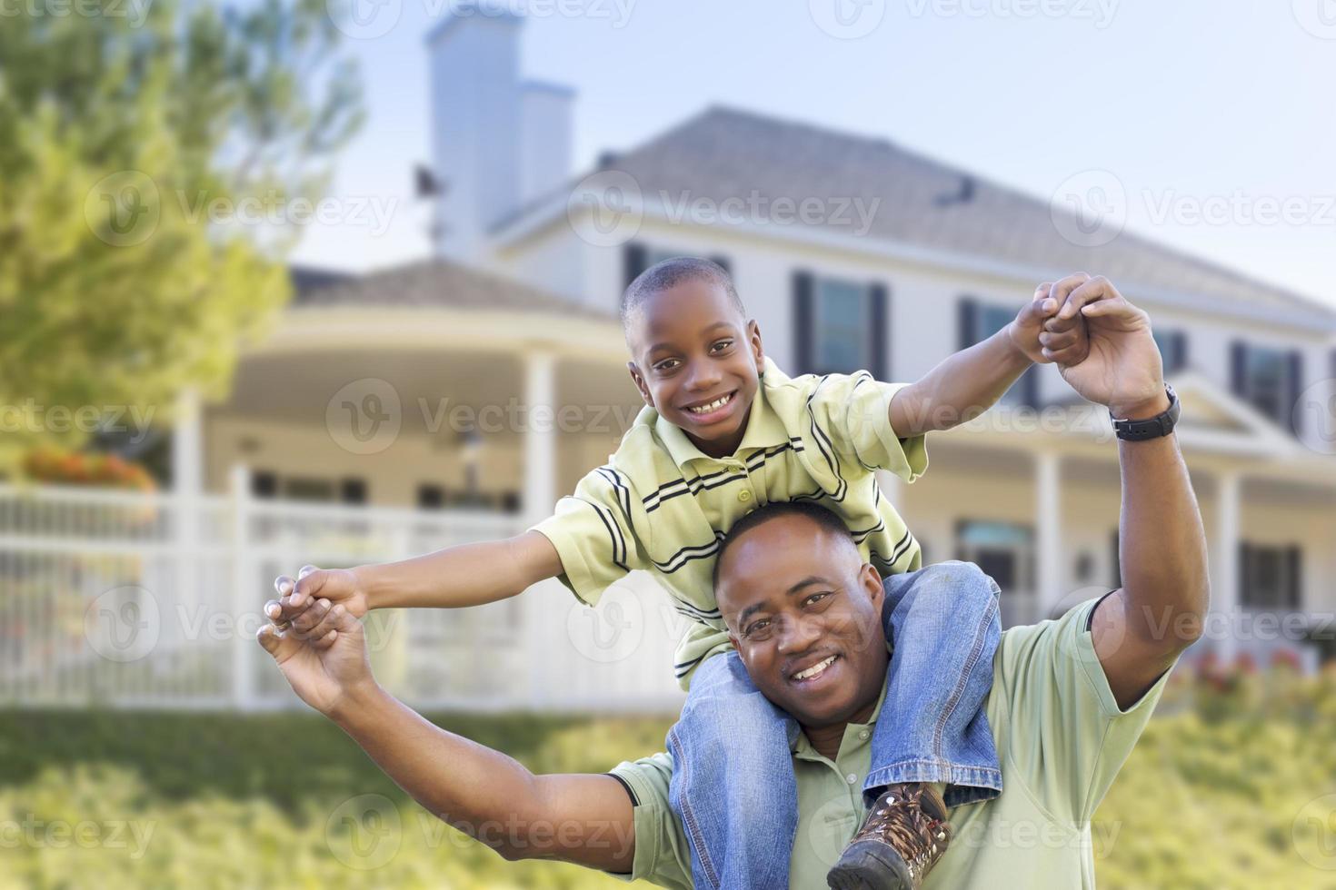 Playful African American Father and Son In Front of Home photo