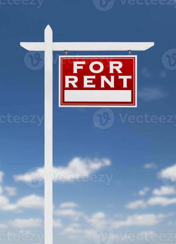 Right Facing For Rent Real Estate Sign on a Blue Sky with Clouds. photo