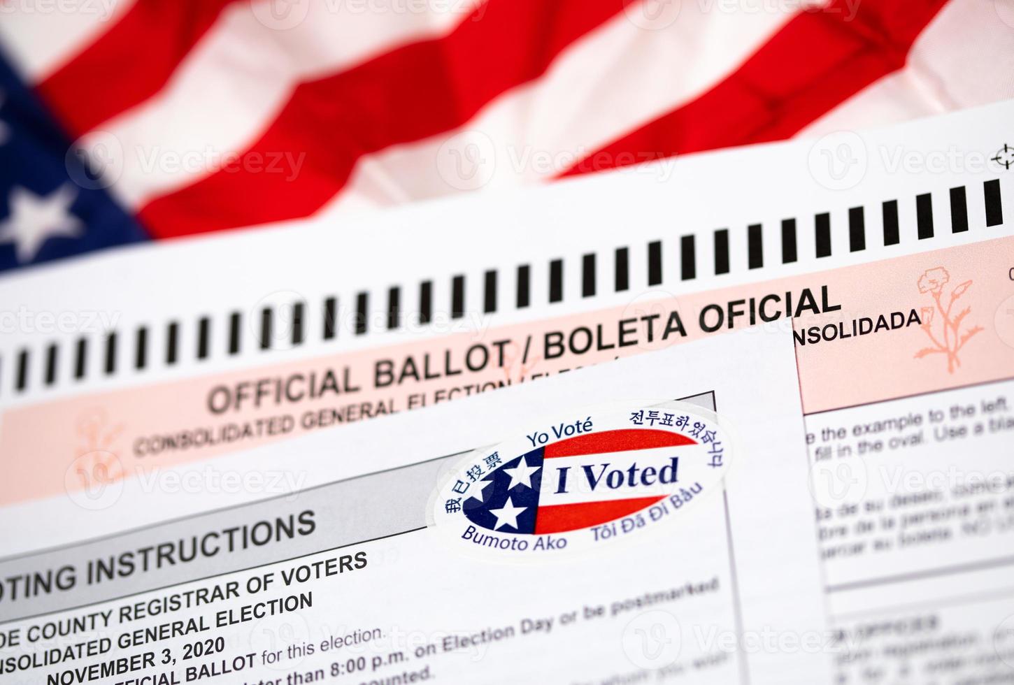 Official Ballot and Voting Instructions with I Voted Sticker Laying on American Flag photo