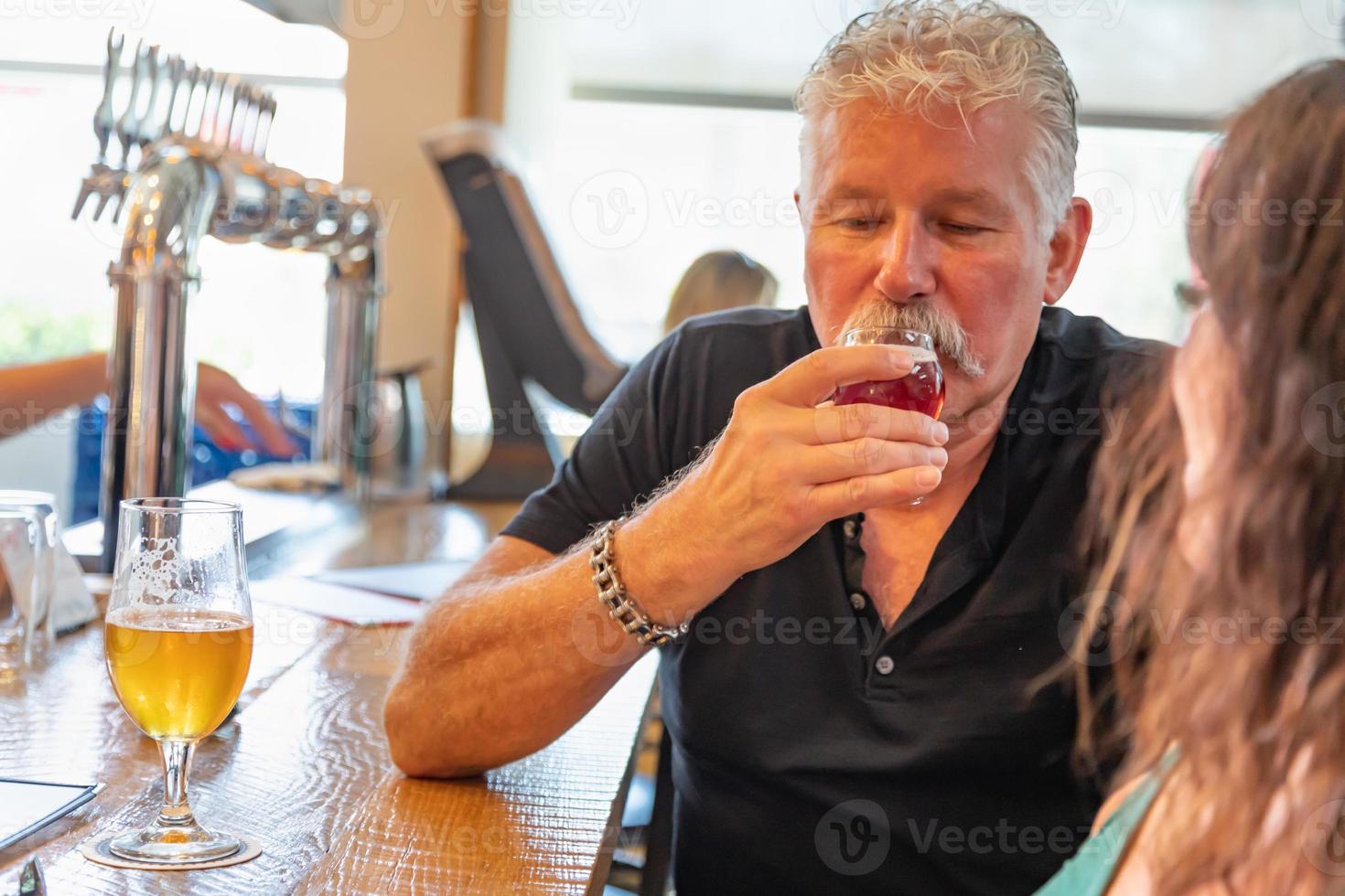 Handsome Man Tasting A Glass Of Micro Brew Beer photo