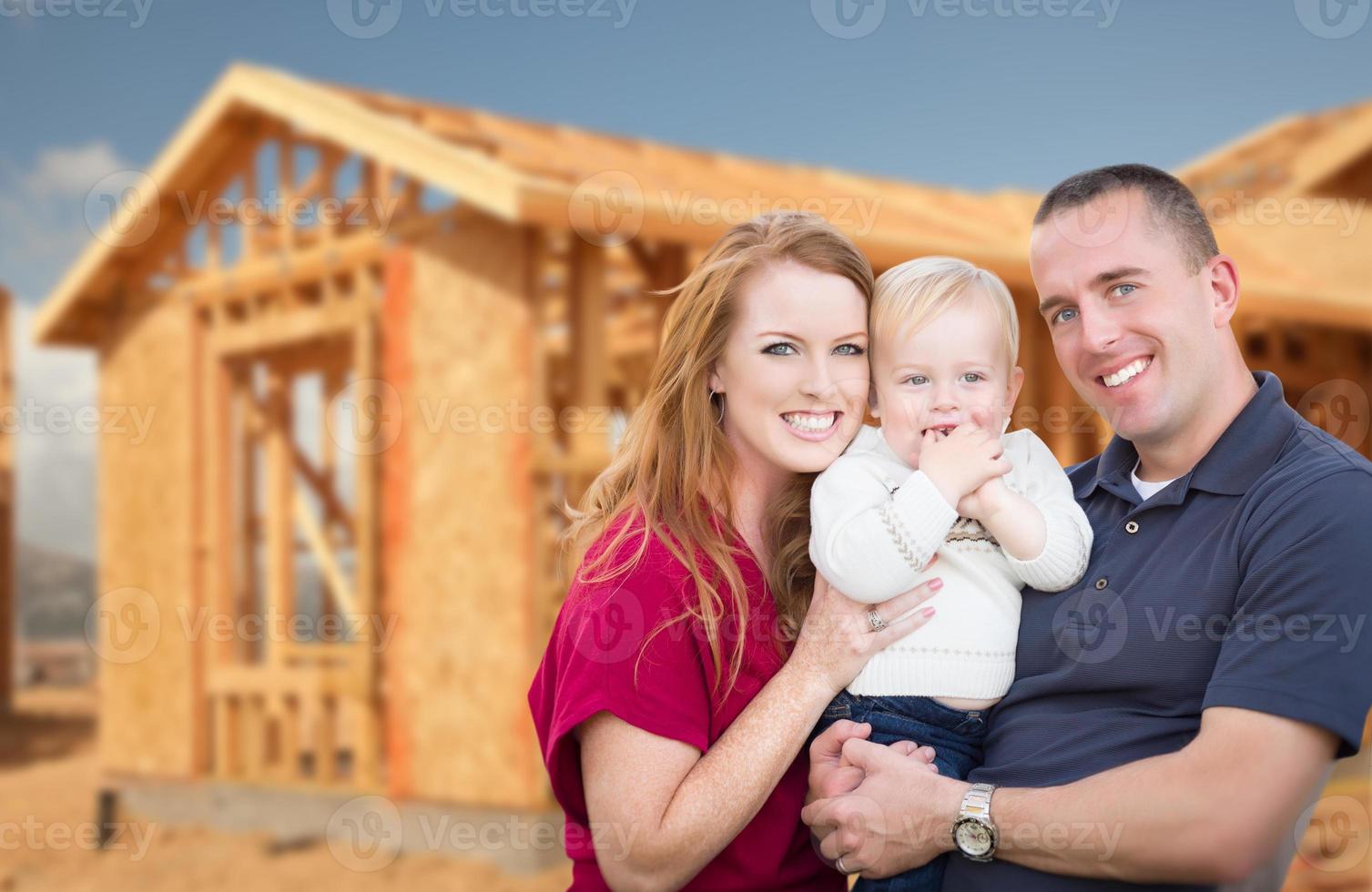 Young Military Family Outside Their New Home Framing photo