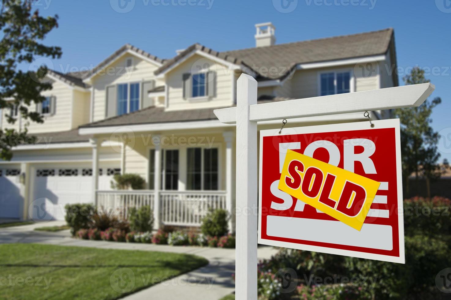 Sold Home For Sale Sign in Front of New House photo