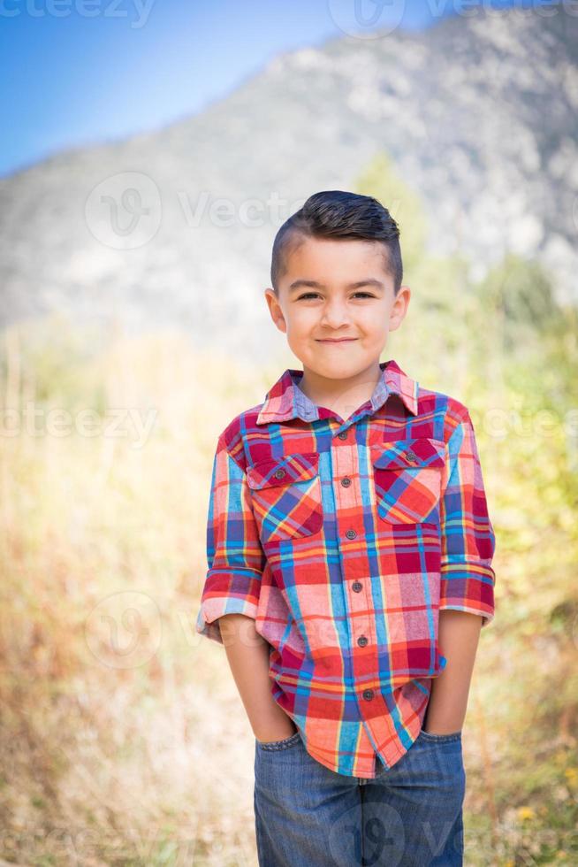 Mixed Race Young Boy Standing Outdoors. photo