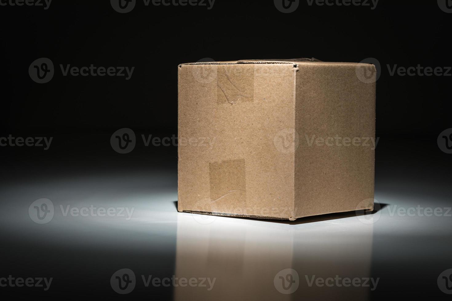 Blank Carboard Shipping Box Under Spot Light. photo