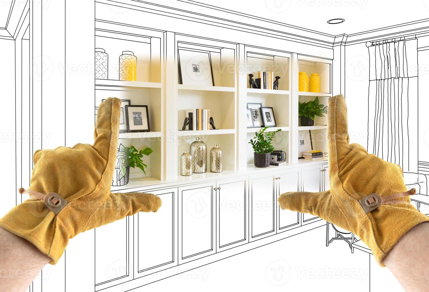 Male Contractor Hands Framing Completed Section of Built In Shelving Over Drawing photo