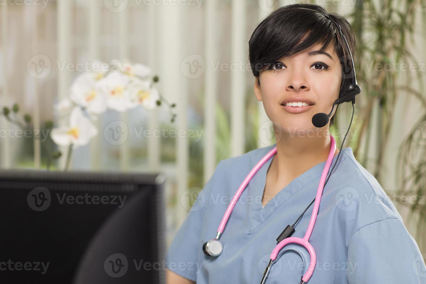 Mixed Race Female Nurse Practitioner or Doctor at Computer photo