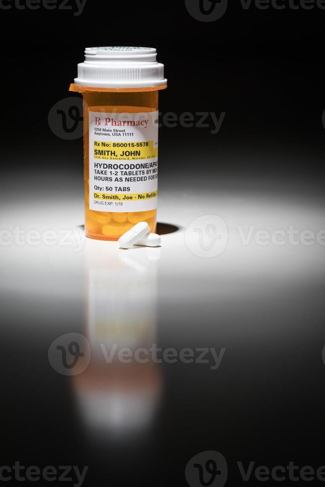 Hydrocodone Pills and Prescription Bottle with Non Proprietary Label. No model release required - contains fictitious information. photo