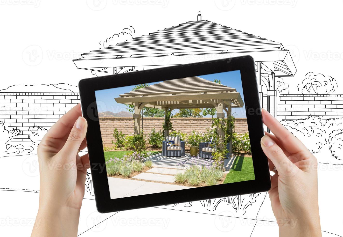 Female Hands Holding Computer Tablet with Photo of Pergola on Screen, Drawing Behind.