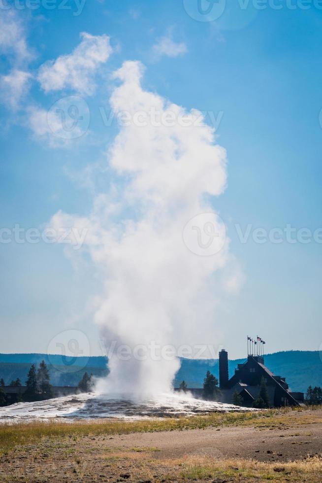 Old Faithful Geyser Erupting at Yellowstone National Park. photo